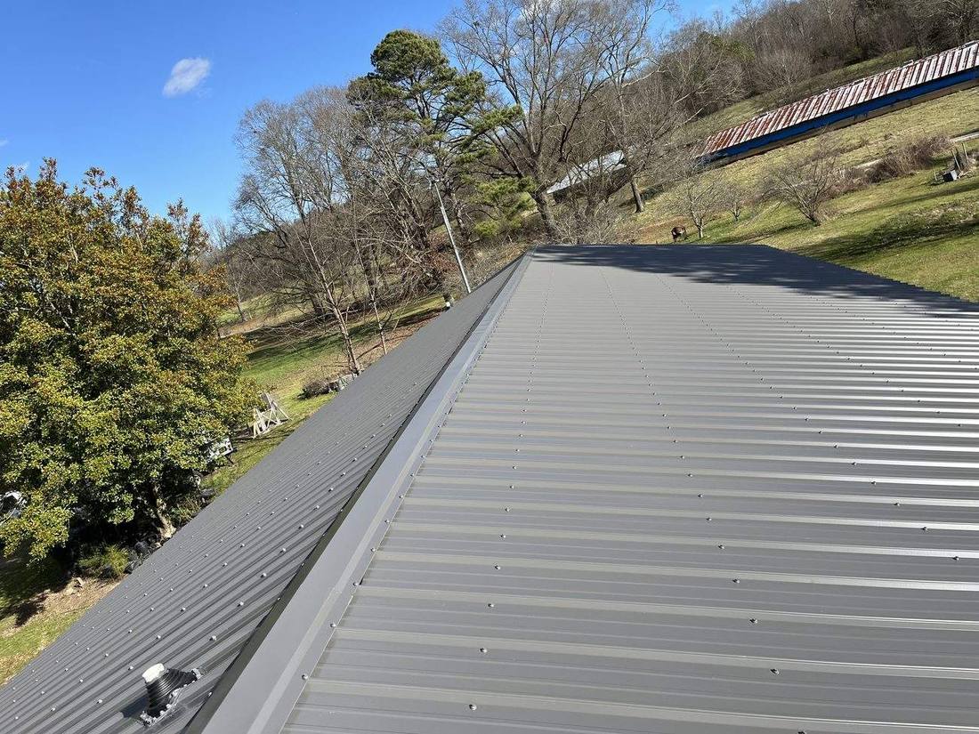 Dark metal standing-seam roof installed by Fortress Roofing