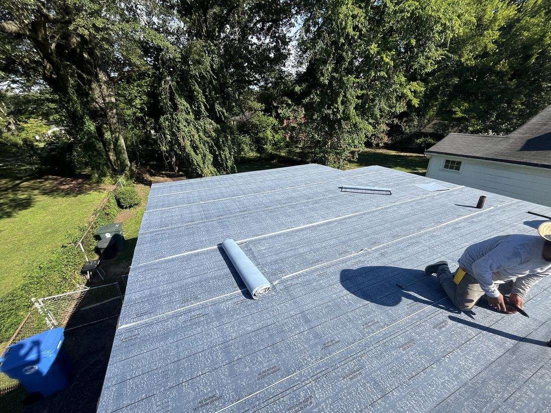 Flat roof repair by Fortress Roofing crew