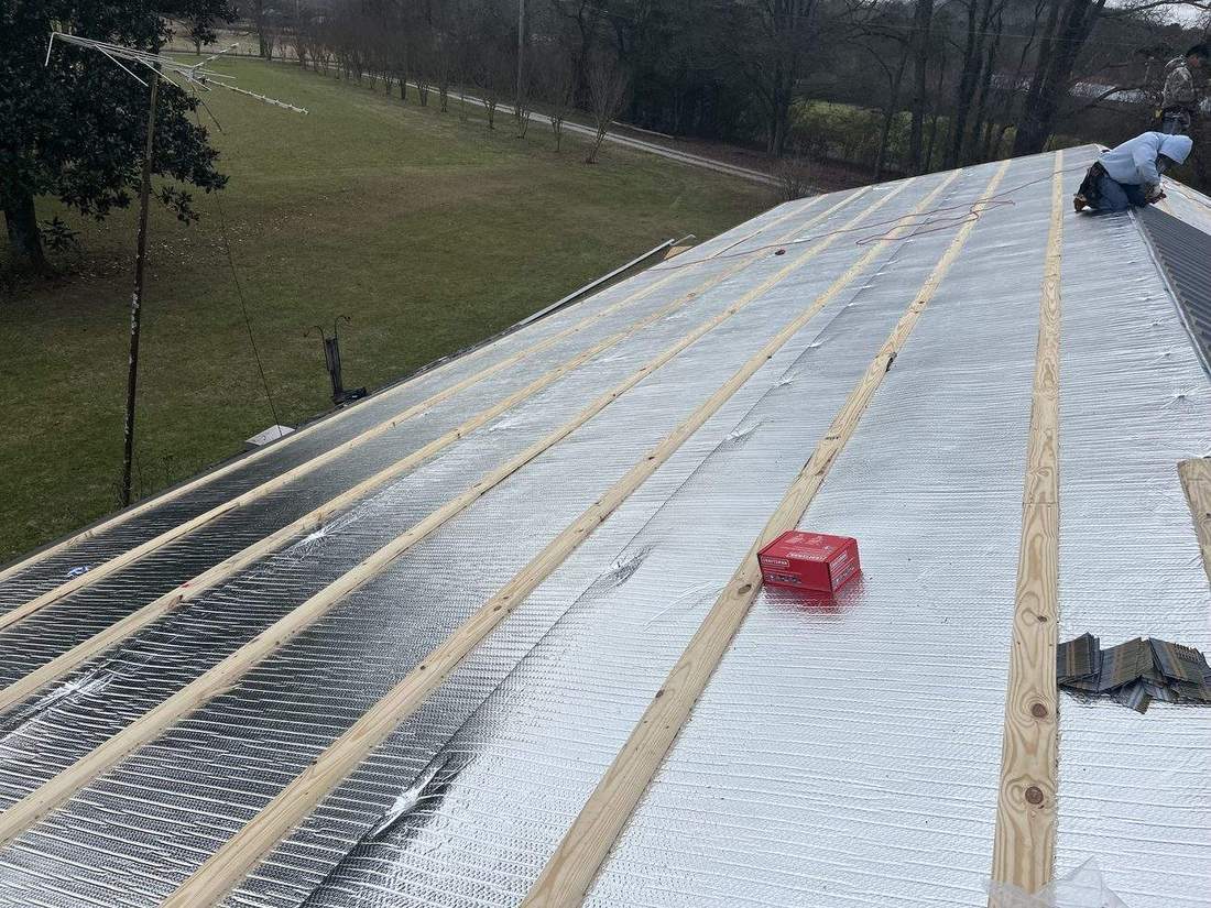 Roofing crew installing underlayment during a full replacement